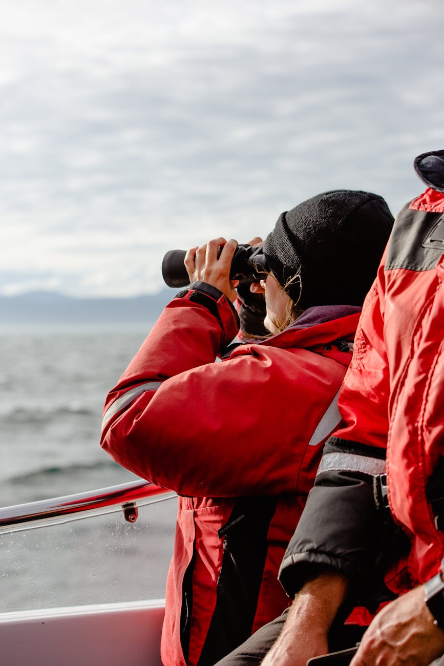 woman on a boat looking through binoculars